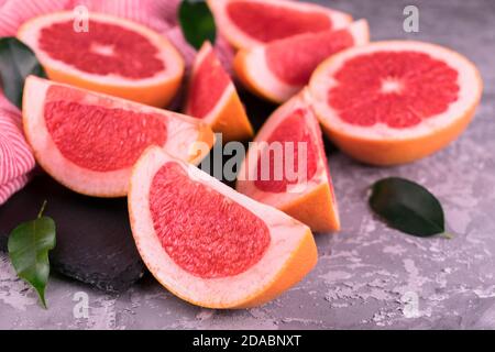 Sliced ​​grapefruit on a gray background. Stock Photo