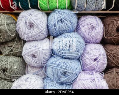 Woolen skeins of thread for knitting are arranged according to colors. Fullscreen photo Stock Photo