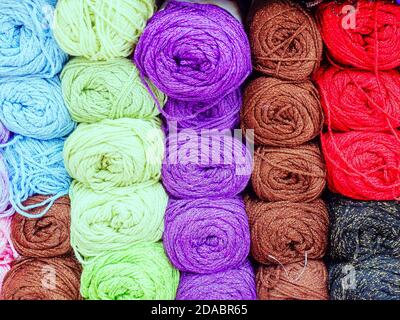 Many colored skeins of thread tightly packed. Full screen photo Stock Photo