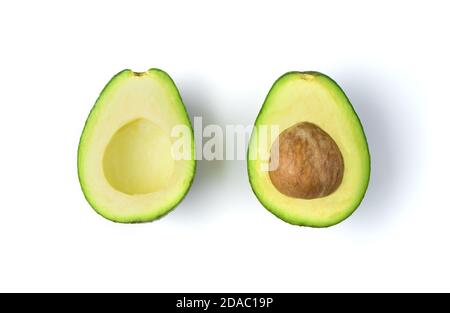 Avocado with a stone cut in half on a white background. Stock Photo