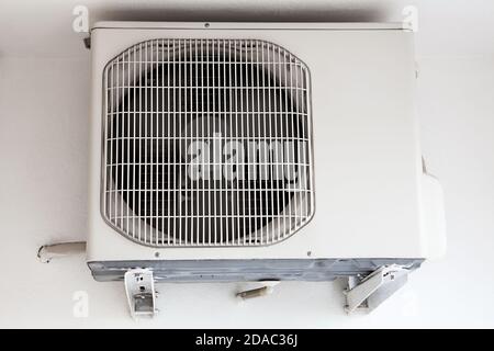 External part of split system air conditioning unit mounted on wall, close-up view Stock Photo