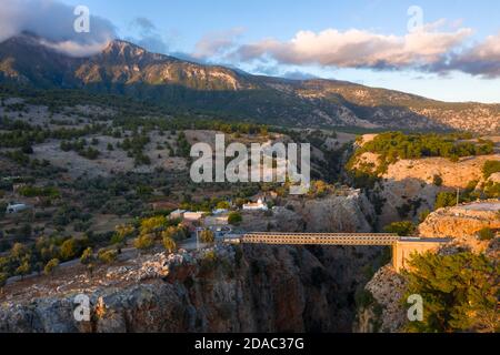 Aerial view over Aradena Gorge at sunset showing Aradena Bridge, Hora Sfakion, Crete Stock Photo