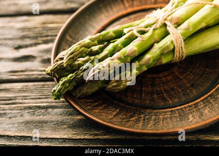 Fresh green asparagus on wooden background Stock Photo