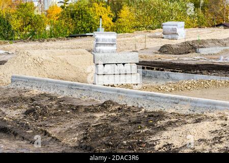 improvement of the city park infrastructure, earthworks for the construction of new asphalt walkways Stock Photo