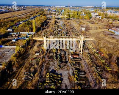 Old rusty broken Russian military cars for scrap metal in industrial area, aerial view Stock Photo