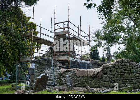 Scaffolding around the arch of a medieval ruin, old church and graveyard in Johnstown, County Kildare, Ireland Stock Photo