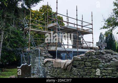 Scaffolding around the arch of a medieval ruin, old church and graveyard in Johnstown, County Kildare, Ireland Stock Photo