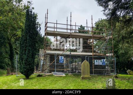 Scaffolding around the arch of a medieval ruin, old church and graveyard in Johnstown, County Kildare, Ireland Stock Photo