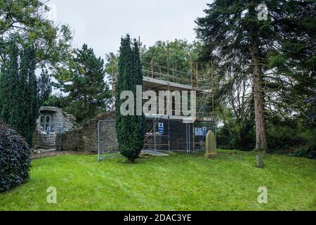 Scaffolding around the arch of a medieval ruin, old church and graveyard in Johnstown, County Kildare, Ireland Stock Photo