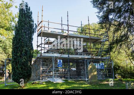 Scaffolding around the arch of a medieval ruin, old church and graveyard in Johnstown, County Kildare, Ireland Stock Photo