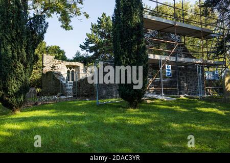 Scaffolding around the arch of a medieval ruin, old church and graveyard in Johnstown, County Kildare, Ireland Stock Photo