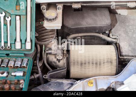 Used air cartridge is in airbox of car engine, close up view Stock Photo