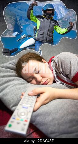 Young Caucasian woman sleeping on couch with daydreams about travel by a motorcycle. TV remote control is in hand Stock Photo