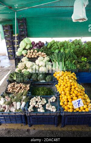 Lemons, garlic, cabbage and other green vegetables are in plastic boxes on sale. Fruit and vegetable marketplace is in the Alanya, Turkey Stock Photo