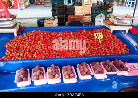 Strawberries are on the counter at the vegetable market in city. Seasonal vegetables and fruits are on sale in large bazaar. Alanya, Turkey Stock Photo