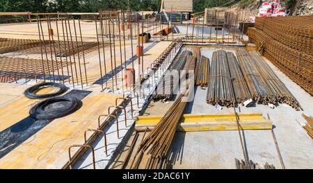 Bundles of steel rebar rods and grids into reinforced cement concrete at building site. Ferroconcrete reinforcing bars. Ceiling and floor slab or wall. Stock Photo