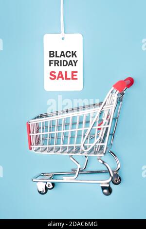 Black friday.Sale tag with text and shopping cart on blue background.Shopping concept Stock Photo