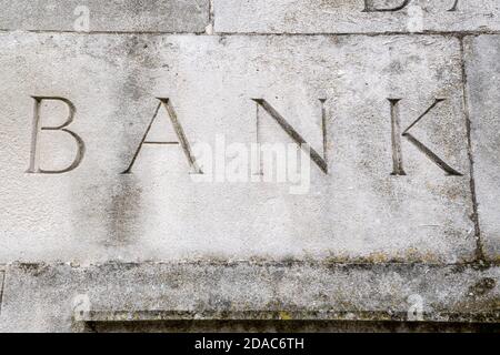 Elegant bank sign carved in to stone wall Stock Photo