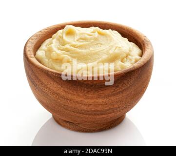 Mashed potato puree in wooden bowl isolated on white background Stock Photo