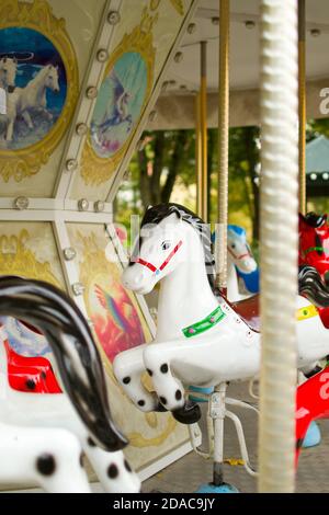 Fragment of Merry-go-round carousel with horses Stock Photo