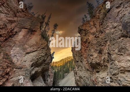 Altai mountains. The so called Red Gates. Beautiful highland landscape. Red mountains in the foreground. Dark orange sunset sky as a background. Russi Stock Photo