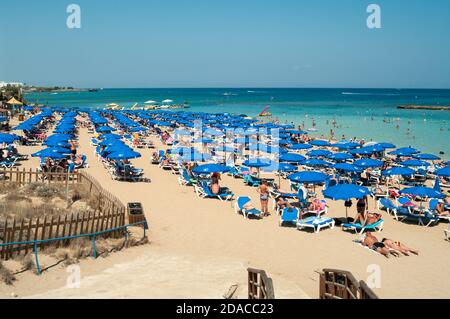 Ayia Napa, Cyprus-circa Sep, 2010: The Fig Tree Bay is full of resting people. It is a Blue Flagged sandy beach in the resort of Protaras and a popula Stock Photo