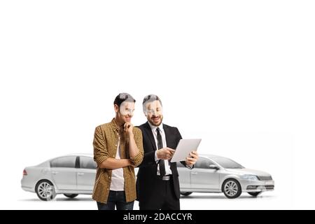 Car salesperson showing a tablet to a smiling young man in a showroom isolated on white background Stock Photo