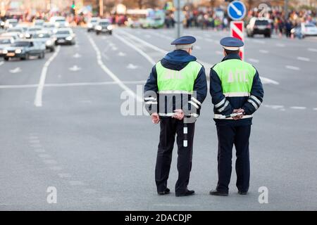 Two officers of traffic control police are on guard at the Victory Day celebration in the World War II. Rear view, full length. The Saint-Petersburg, Stock Photo