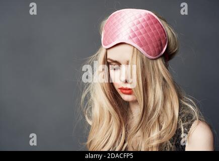 Girl With A Bad Appearance, In A Bra And Mask For Sleeping, Holds A Bottle  Of Alcohol And Looks At It. Stock Photo, Picture and Royalty Free Image.  Image 92392163.