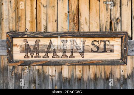 Old weathered vertical pine wood plank background with Main Street Sign Stock Photo