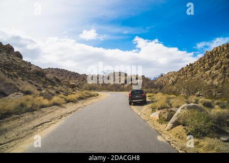 View of a car in the middle of the nature in Alabama Hills in California, USA Stock Photo