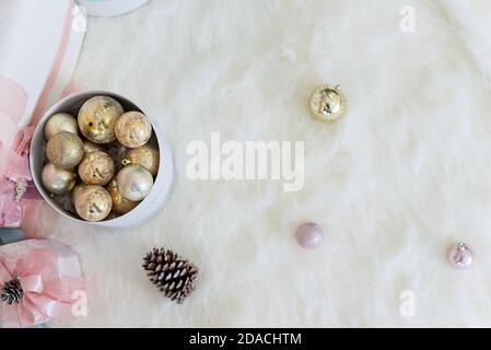 New Year greeting card. Craf boxes with gifts from Santa Claus lie on white fur under a snowy Christmas   tree decorated with glass toys, pink balls Stock Photo