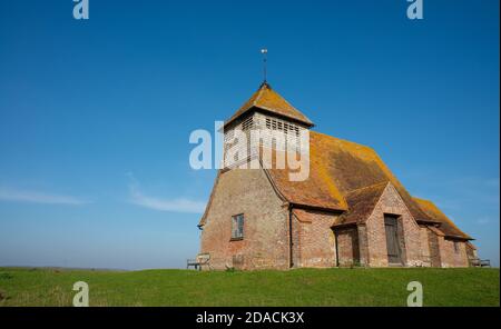 St. Thomas Becket church on a bright sunny afternoon, is an English 13th century church which sits isolated on marshland at Fairfield, Kent, England.