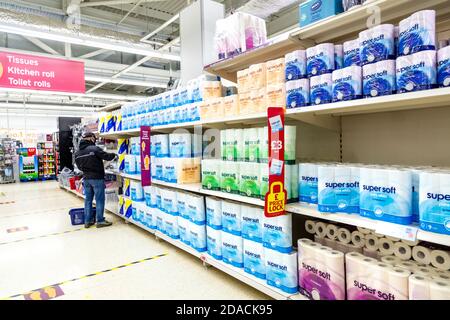 2nd November 2020 - Supermarket shelves stocked with toilet paper during second lockdown at ASDA supermarket, Stepney, London, UK, man shopping for to Stock Photo