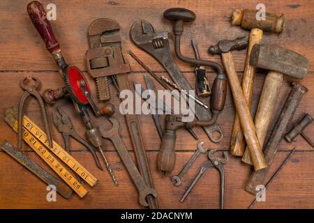 Collection of old vintage tools on a wooden background. Stock Photo