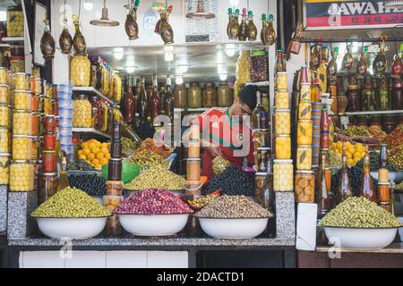 Marrakech, Morocco - APRIL 26 2019: Shop with maroccan products in the center of Medina, view of the salesman in the daylight Stock Photo