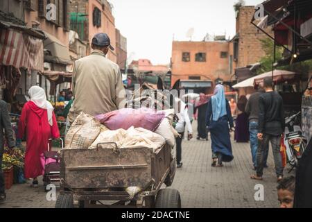 Marrakech, Morocco - APRIL 26 2019: citizens and tourists walking in the crowded streets of center Medina during the day Stock Photo