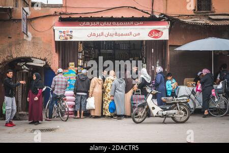 Marrakech, Morocco - APRIL 26 2019: Citizens waiting in a queue at a shop in the middle of Medina Stock Photo