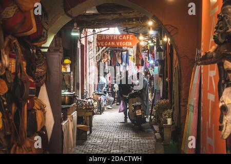 Marrakech, Morocco - APRIL 26 2019: View of a busy crowded street with shops and salesmen in center of Medina Stock Photo