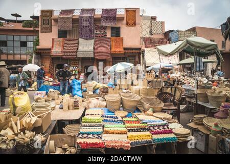 Marrakech, Morocco - APRIL 26 2019: View of the shops and the salesmen in the center of Medina in the daylight Stock Photo