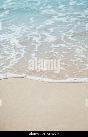 Soft blue ocean wave on sandy beach. Background. Stock Photo