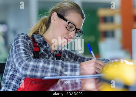 a female worker writing something Stock Photo