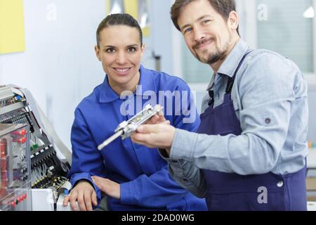 young attractive students of mechatronics working on project Stock Photo