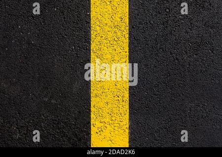 texture tarmac highway road surface with yellow marking smooth dark gray asphalt with copy space close up top view, nobody. Stock Photo