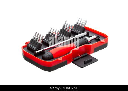 a set of working tools with a screwdriver and bits for repair in an open plastic box with iron nozzles, an object isolated on a white background view. Stock Photo