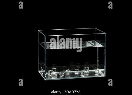 Glass aquarium isolated on black background. Ice cubes in the aquarium. rectangle aquarium glass Stock Photo