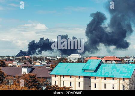 Black smoke from fire burning in residential area Stock Photo