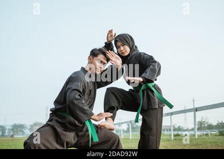 Asian male poses with pencak silat moves while wearing a pencak silat ...