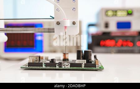 Debugging electronics device. PCB witch microcontroller in electronics laboratory Stock Photo