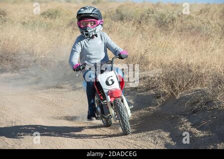 Pre-teen riding mini-dirt bike on a dirt track in Ada County, Idaho, USA Stock Photo